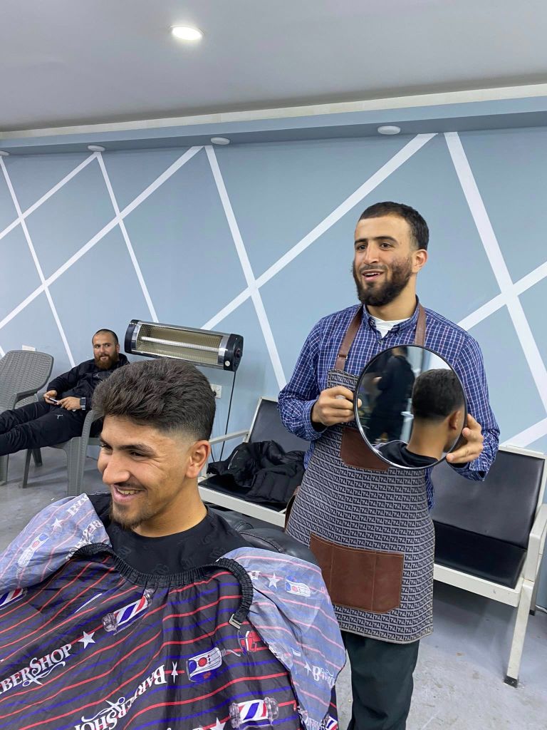 Barber showing client result in mirror